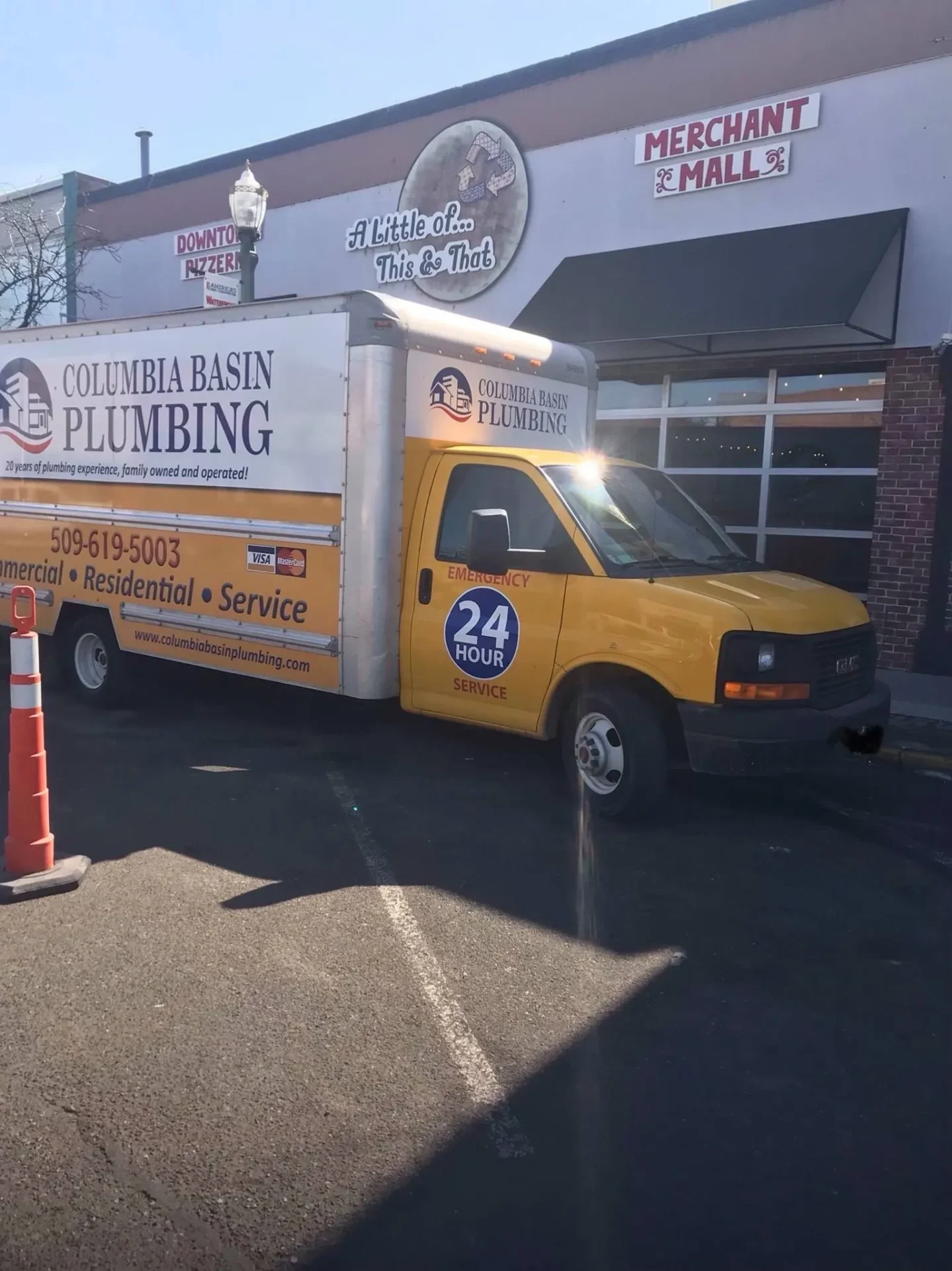 A yellow truck parked in front of a building.