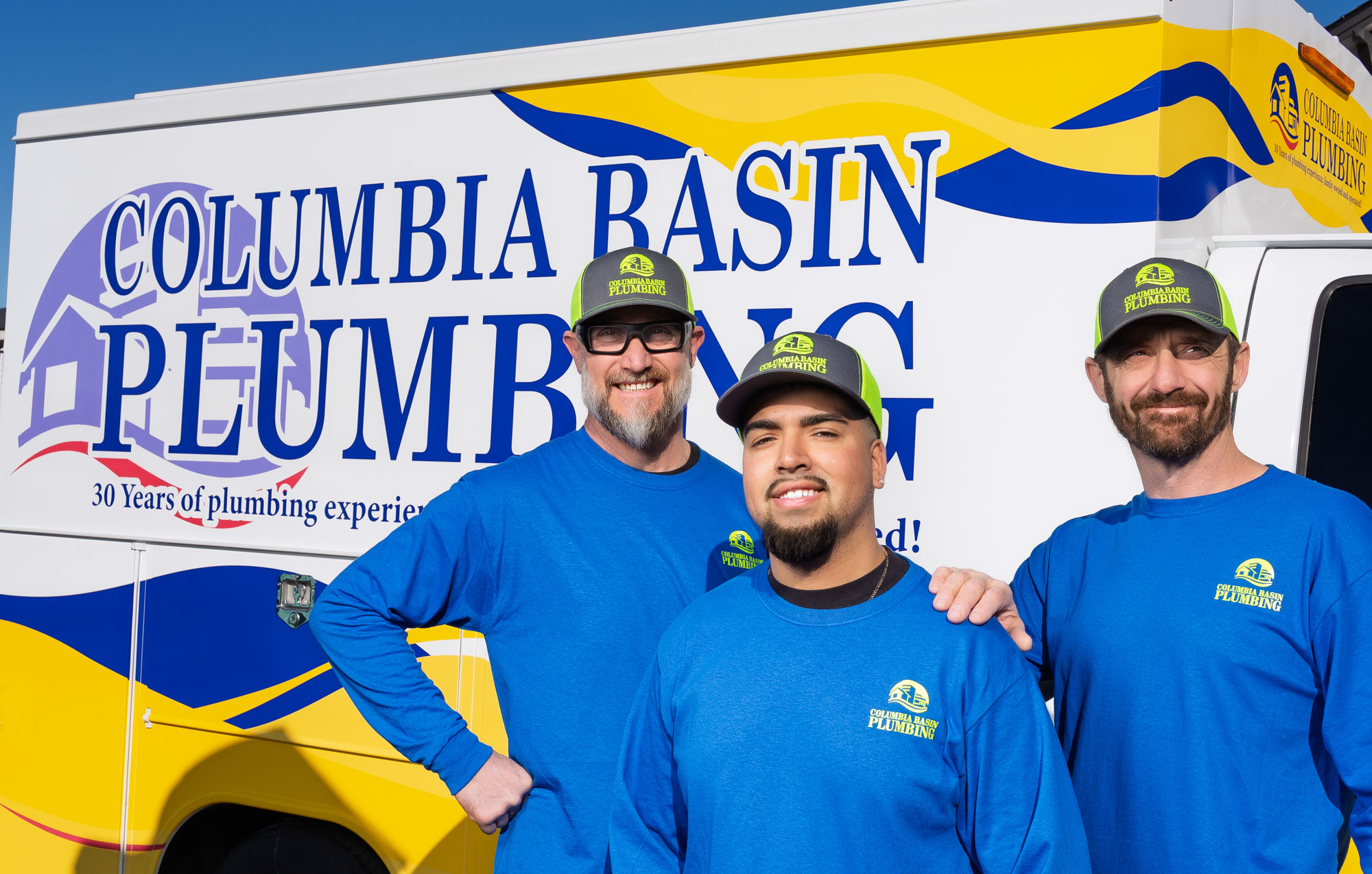 Columbia Basin Plumbing team by service truck.