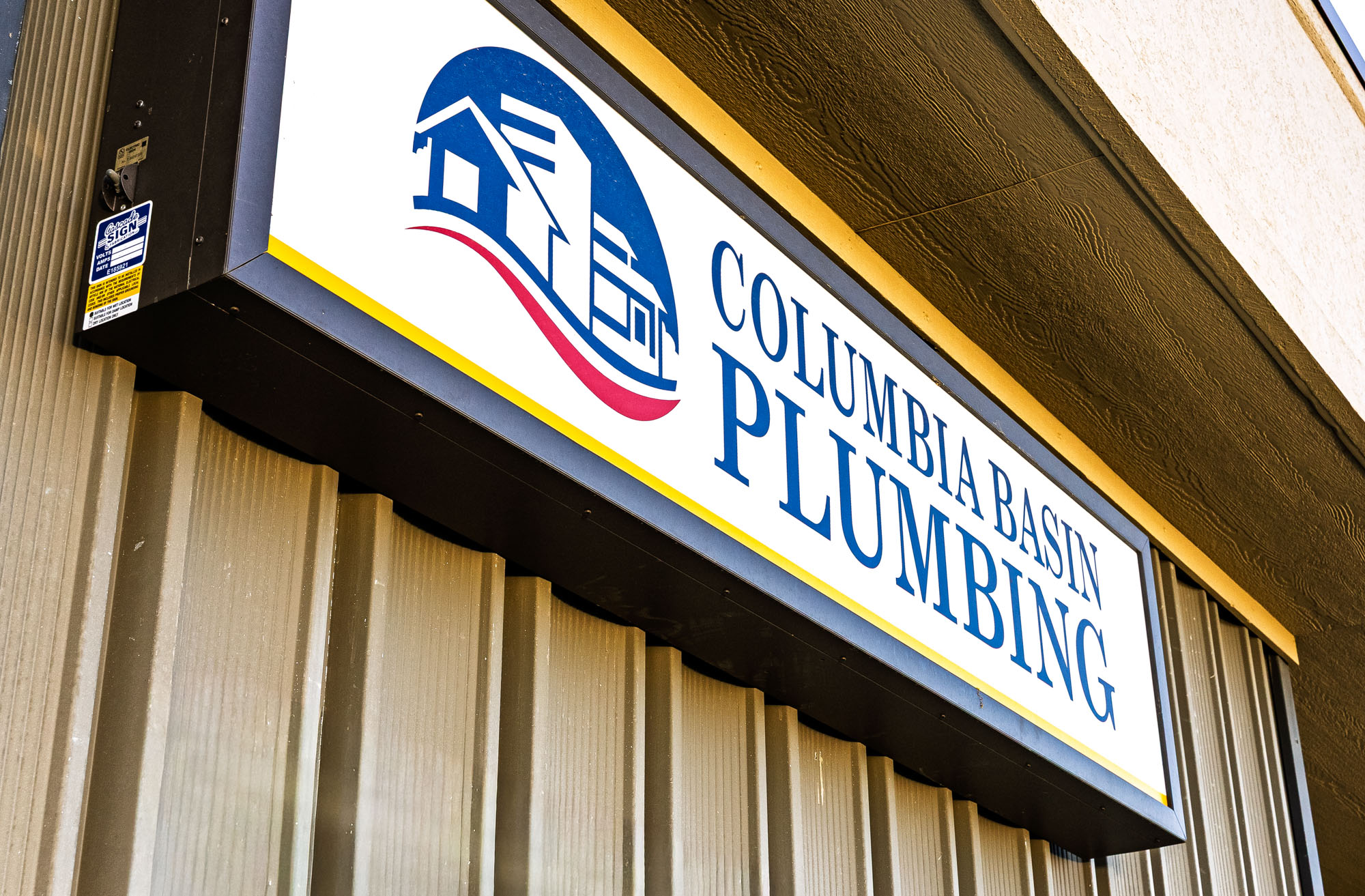Columbia Basin Plumbing storefront sign on building exterior