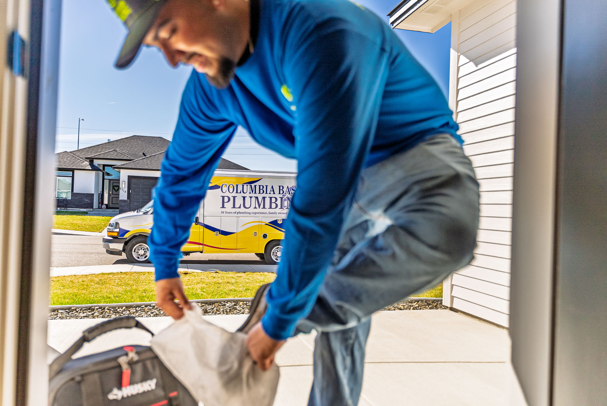 Plumber arriving at house with tools.